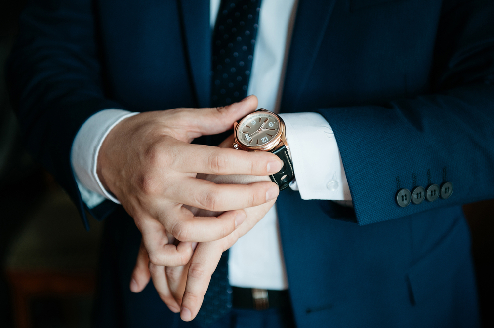 guy checking watch shutterstock 398159059